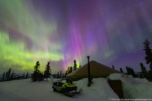 Aurora over Yurt & Snowmobile in Alaska